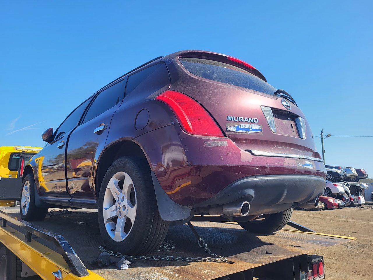 Late-model SUV secured on a flatbed tow truck